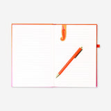 Gradient office notebook with magnetic bookmark and pen by Flying Tiger Copenhagen, open showing colorful pages and accessories.