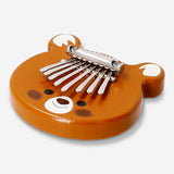 Wooden kalimba toy from Flying Tiger Copenhagen with seven metal tines and a compact, natural wood finish.