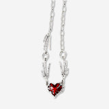 Silver textile necklace with a red heart pendant, stylish accessory from Flying Tiger Copenhagen.