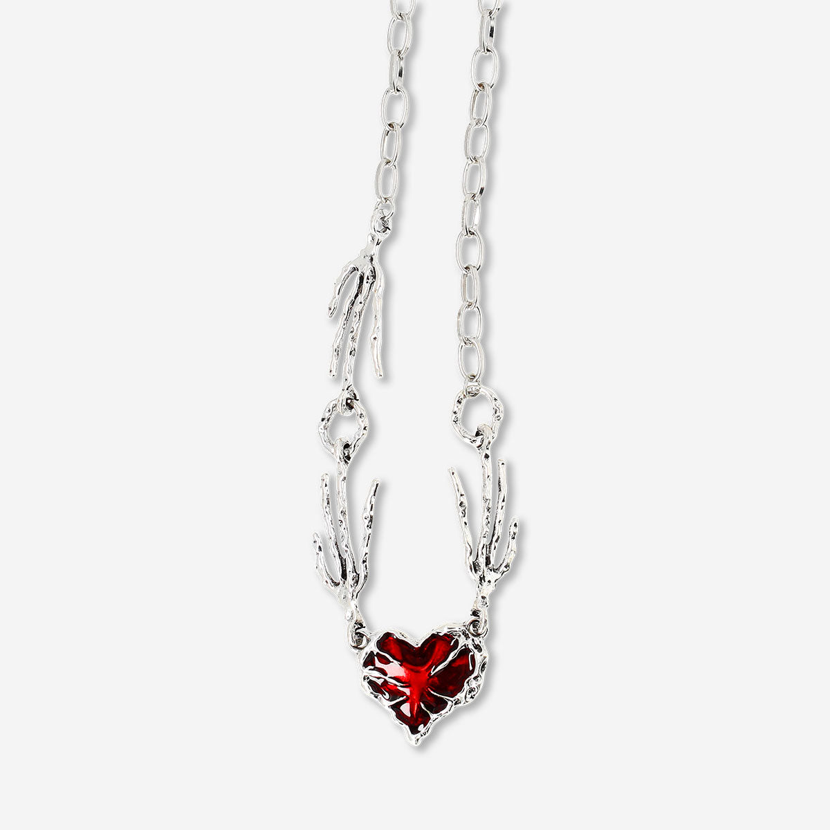 Silver textile necklace with a red heart pendant, stylish accessory from Flying Tiger Copenhagen.