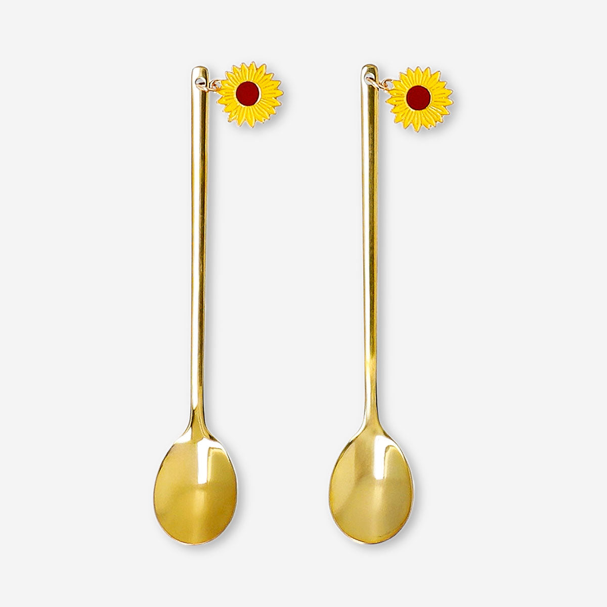 Two gold dessert spoons with sunflower toppers, decorative kitchen utensils by Flying Tiger Copenhagen, shown on a white background.