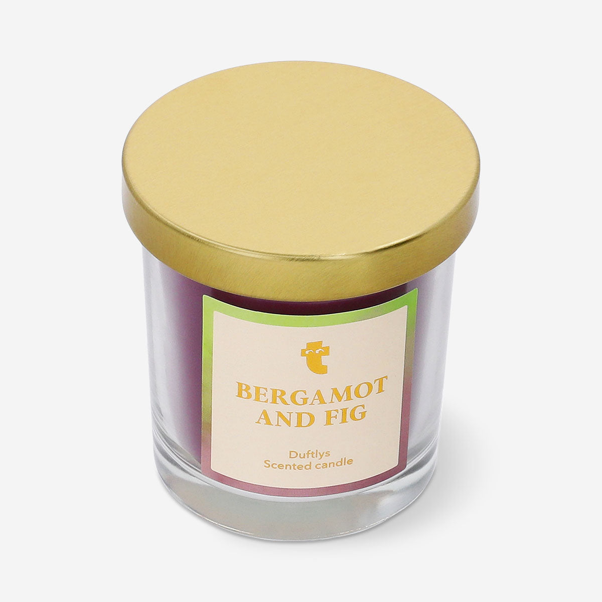Flying Tiger Copenhagen scented candle with bergamot and fig fragrance, showcasing a decorative candle in a glass holder.