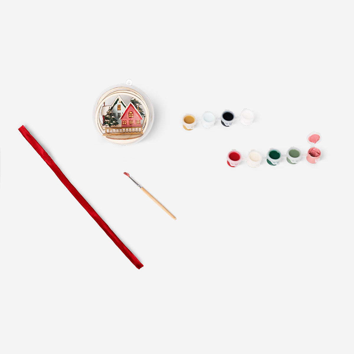 DIY wooden bauble hobby craft by Flying Tiger Copenhagen, showing a small unfinished wooden ornament with paint and decorative details.