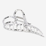 Silver heart textile hair clip by Flying Tiger Copenhagen, featuring a shiny heart-shaped design for stylish hair accessories.