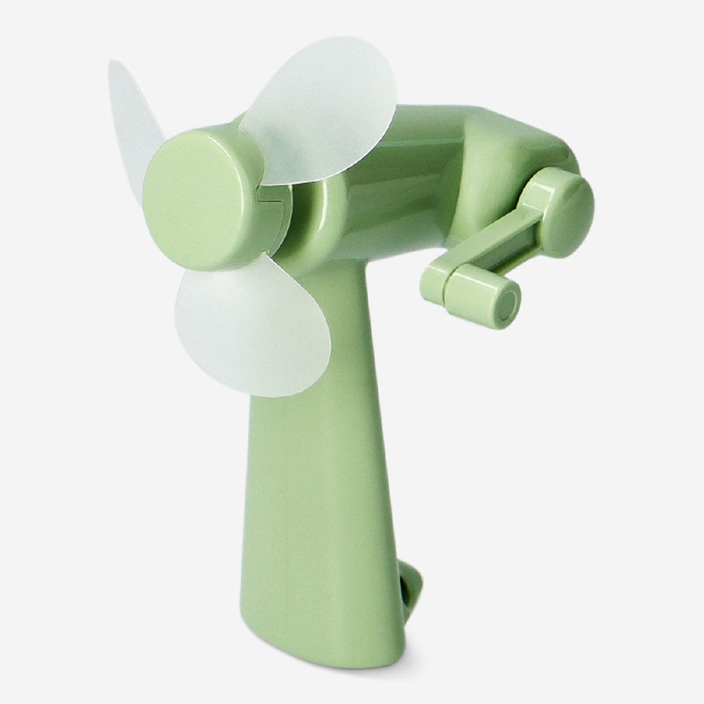 Green handheld fan gadget by Flying Tiger Copenhagen, lightweight and portable for personal cooling.