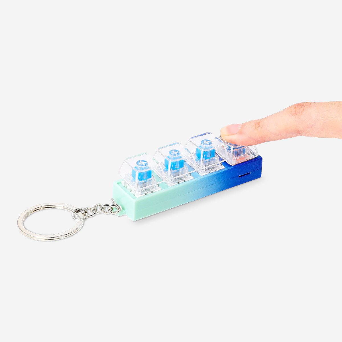 Flying Tiger Copenhagen clicking keyring gadget with built-in light, featuring a compact design and a fun clicking mechanism.