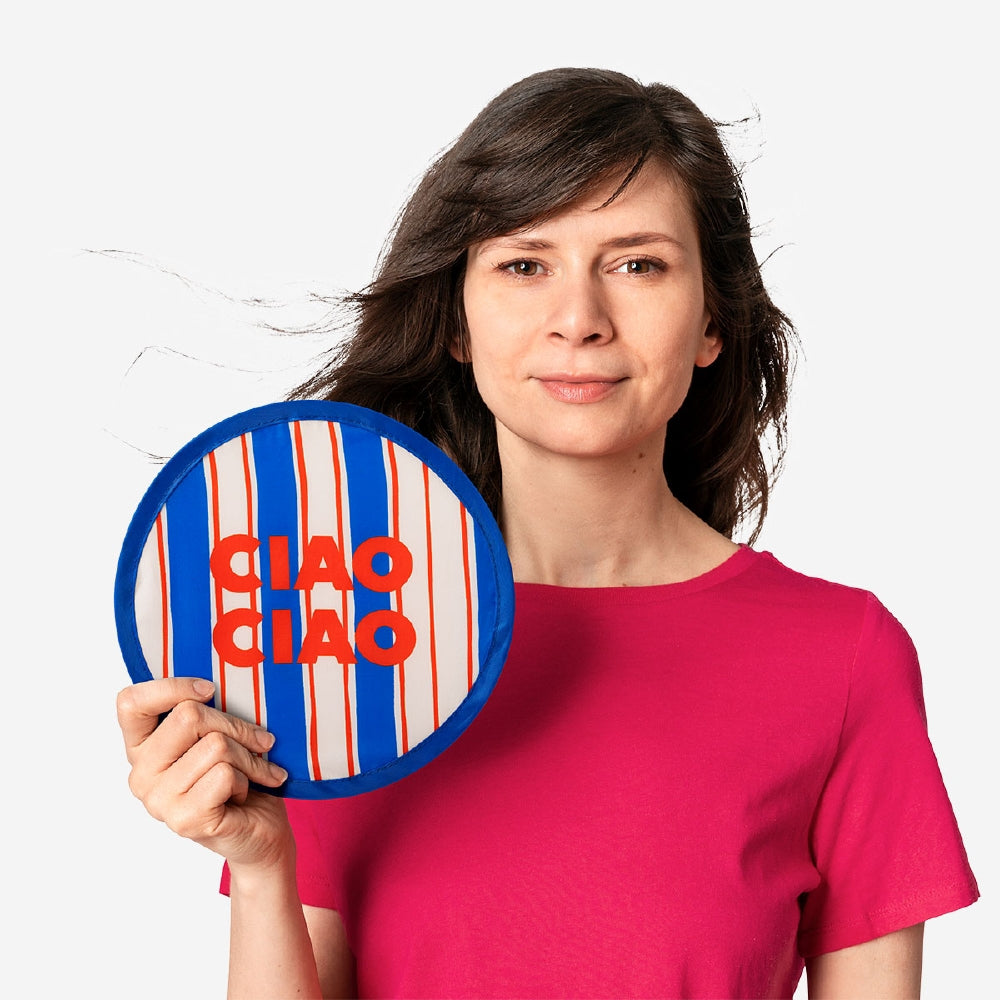 Foldable textile fan with Ciao Ciao print by Flying Tiger Copenhagen, shown partially open with vibrant colorful design.