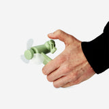 Green handheld fan gadget from Flying Tiger Copenhagen, compact and portable with a foldable design and ergonomic handle.