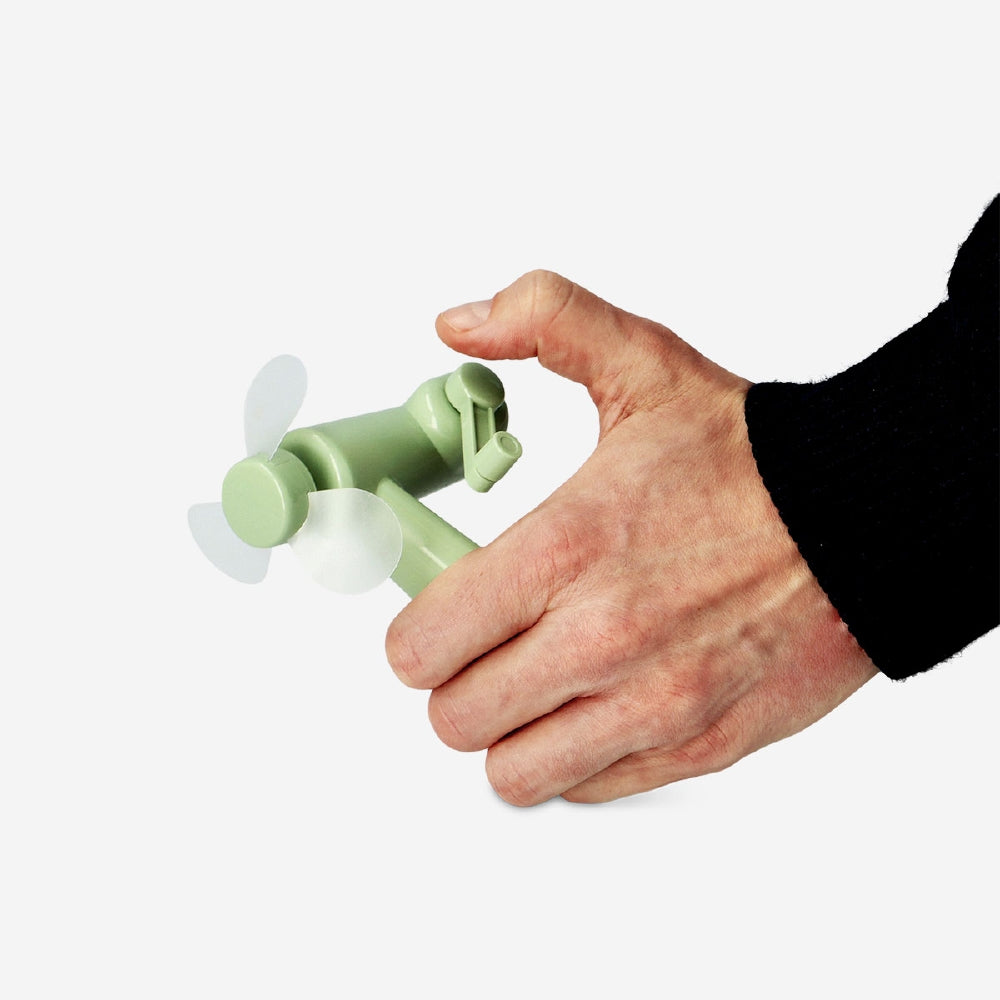Green handheld fan gadget from Flying Tiger Copenhagen, compact and portable with a foldable design and ergonomic handle.