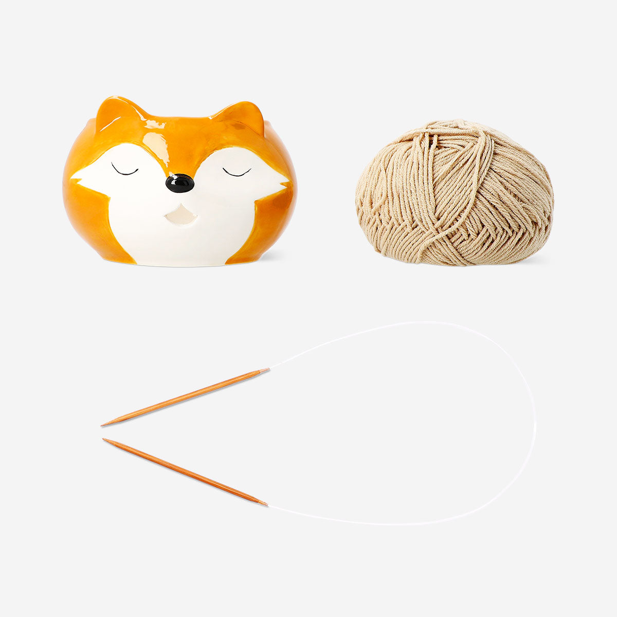 Colorful knitting set with ceramic yarn bowl for hobby knitting, featuring needles, yarn, and accessories in a vibrant display.