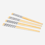 Eight printed kitchen chopsticks by Flying Tiger Copenhagen, featuring colorful patterns, ideal for Asian cuisine dining.
