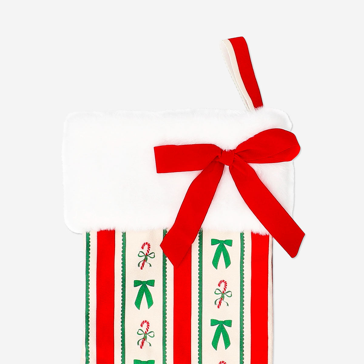 Velvet Christmas stocking in red with white cuff, hanging on a festive home fireplace, by Flying Tiger Copenhagen.