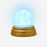 Flying Tiger Copenhagen scrying ball gadget with glowing light, featuring a transparent sphere with illuminated interior.