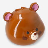 Brown bear money bank from Flying Tiger Copenhagen, 11 cm tall, made of ceramic with a coin slot on its back.