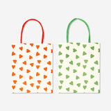 Two office gift bags with heart designs from Flying Tiger Copenhagen, featuring bright colors and decorative handles.