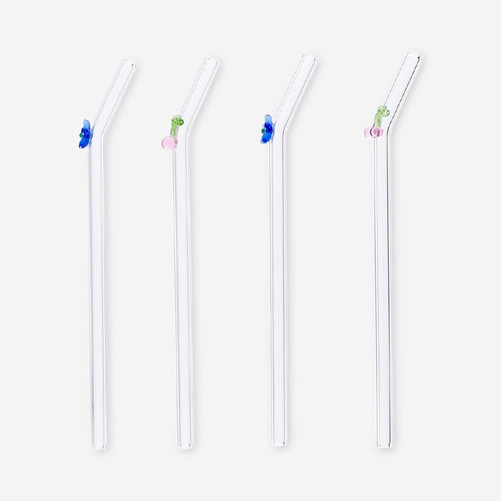 Set of four glass straws with flower and cherry decorations from Flying Tiger Copenhagen, ideal for colorful beverages.