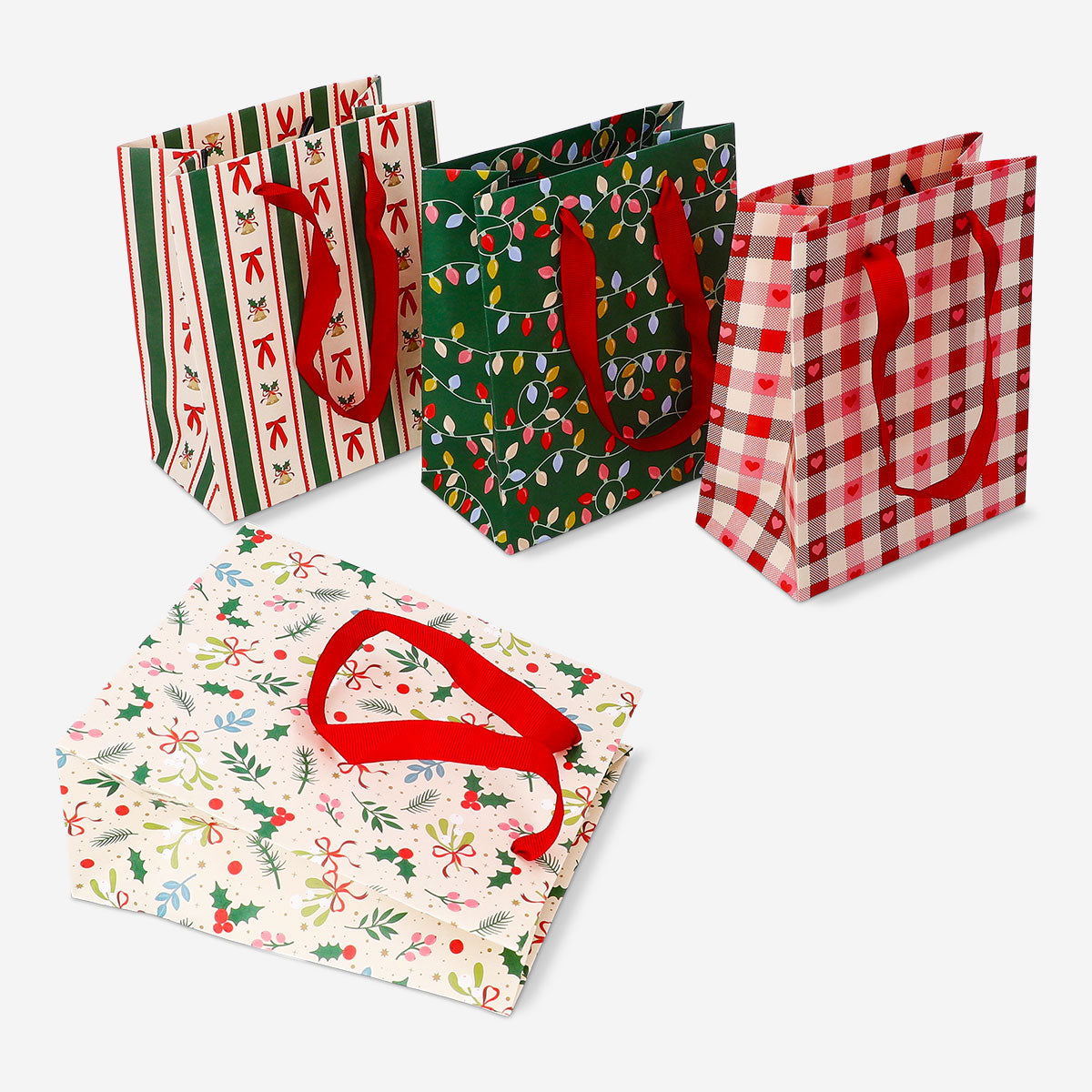 Set of four Christmas pattern gift bags by Flying Tiger Copenhagen, ideal for office holiday presents.
