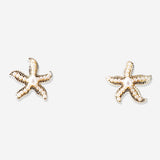 Textile stud earrings featuring seastars with pearls, designed by Flying Tiger Copenhagen, displayed on a neutral background.