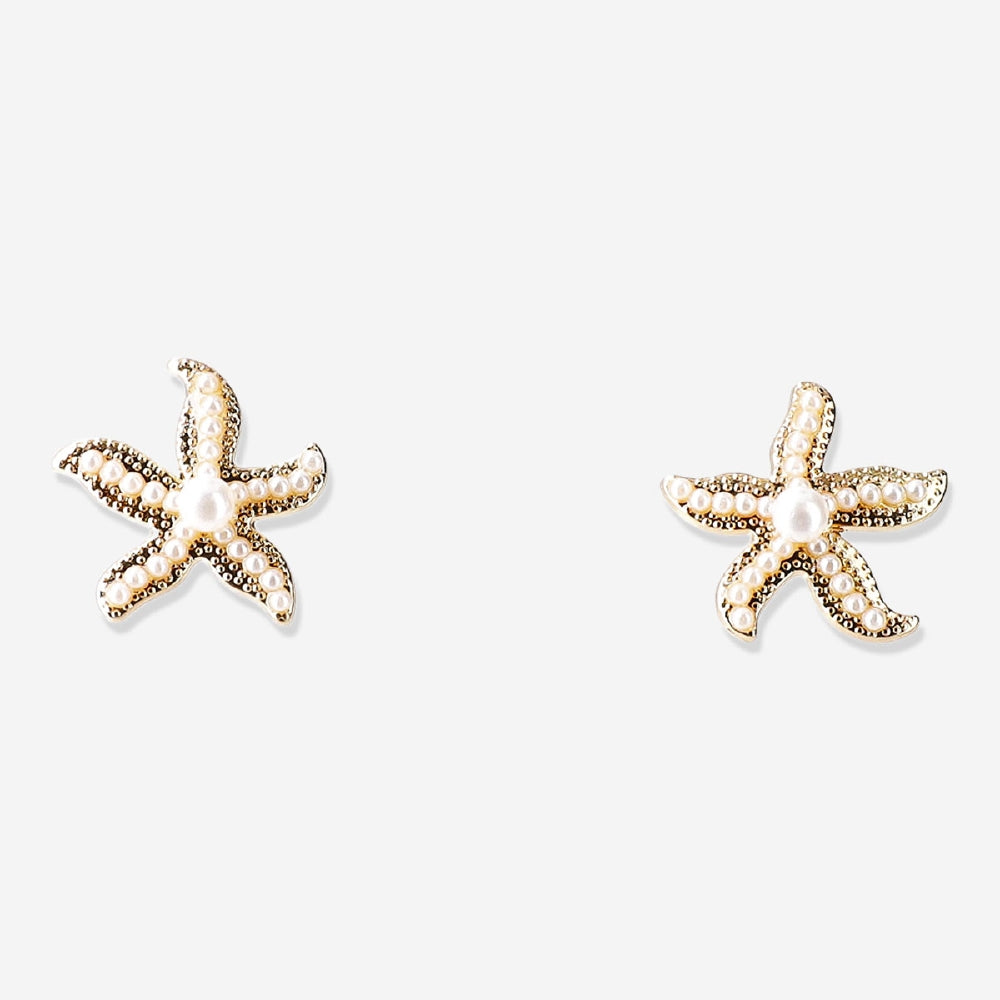 Textile stud earrings featuring seastars with pearls, designed by Flying Tiger Copenhagen, displayed on a neutral background.