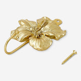 Gold flower hook for home, Flying Tiger Copenhagen, decorative metal wall hook with floral design for hanging items.