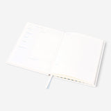 Flying Tiger Copenhagen office recipe book with colorful pages and creative culinary ideas inside.