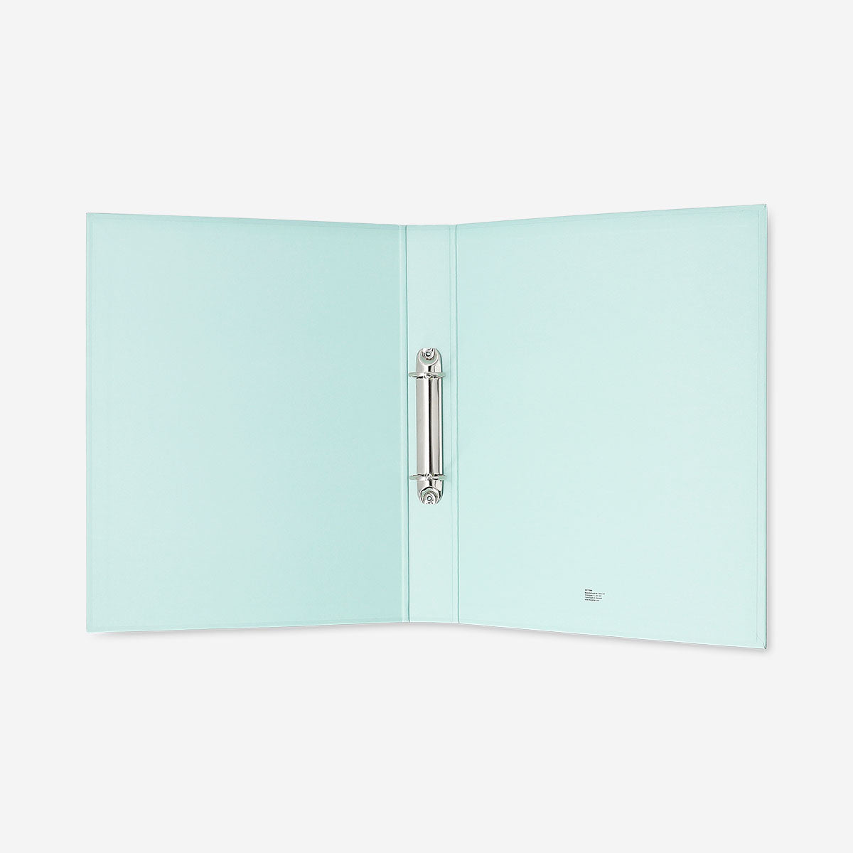 Green office ring binder from Flying Tiger Copenhagen with metal rings and a smooth cover for organizing documents.