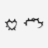 Black textile studded heart earrings with a bold, textured design, featuring small decorative studs for a stylish look.