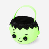 Green zombie trick or treat bucket for Halloween party by Flying Tiger Copenhagen, featuring a spooky zombie face design.