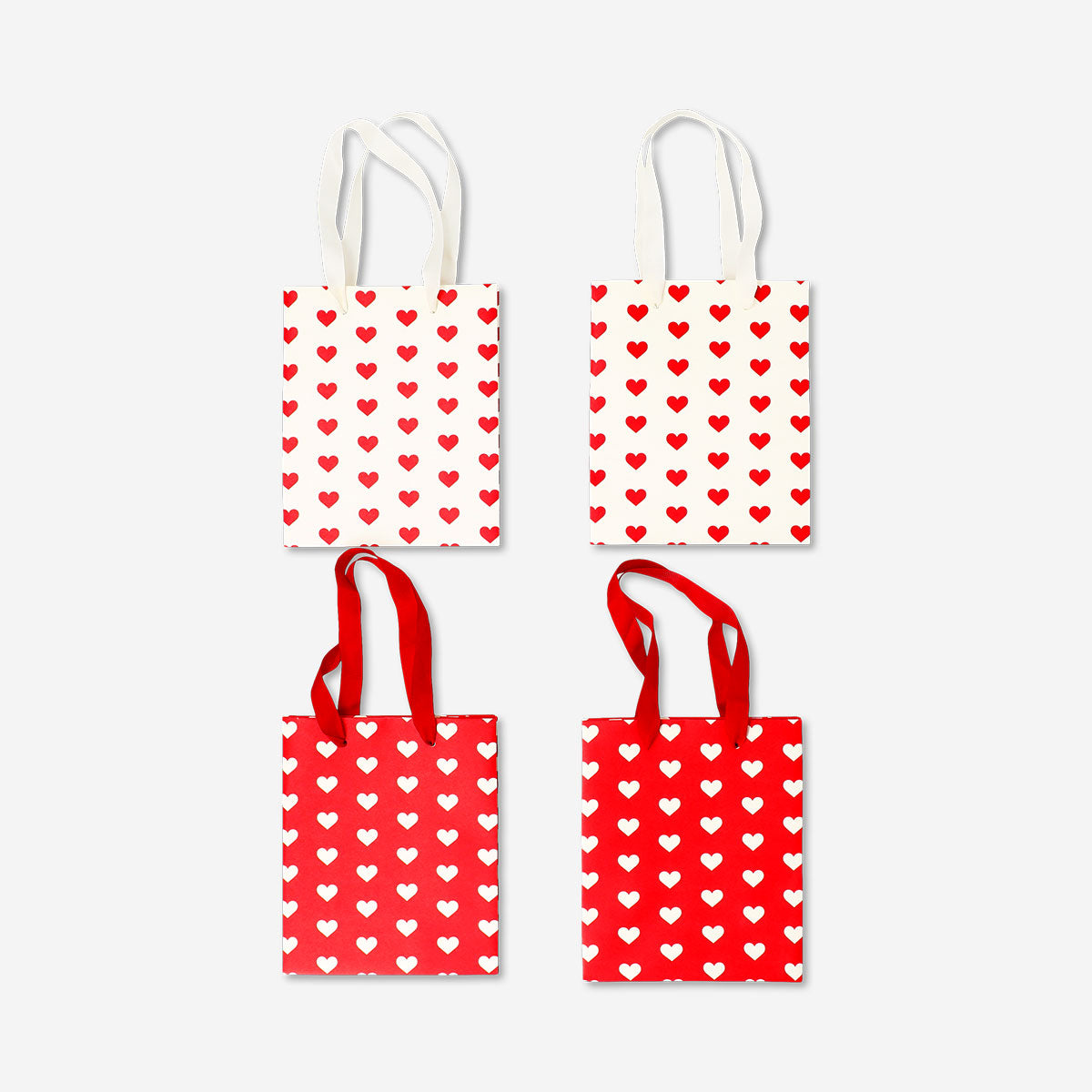 Set of four Flying Tiger Copenhagen gift bags with heart print, ideal for office gifting and special occasions.