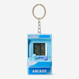 Flying Tiger Copenhagen blue arcade game keyring, a small gadget with a colorful arcade game design on a metal keychain.