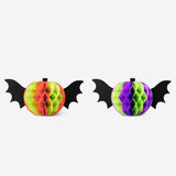 Two Honeycomb paper pumpkin party decorations with wings, colorful and lightweight, perfect for festive table settings.