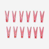 Pink flower clothes pegs set of 12 from Flying Tiger Copenhagen, colorful home laundry clips with floral design on a white background.
