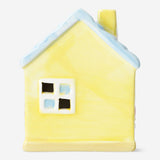 Decorative yellow ceramic house, 13 cm tall, from Flying Tiger Copenhagen, with detailed windows and roof, perfect for home decor.