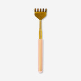 Gold telescopic back scratcher gadget from Flying Tiger Copenhagen with extendable handle for easy back scratching.