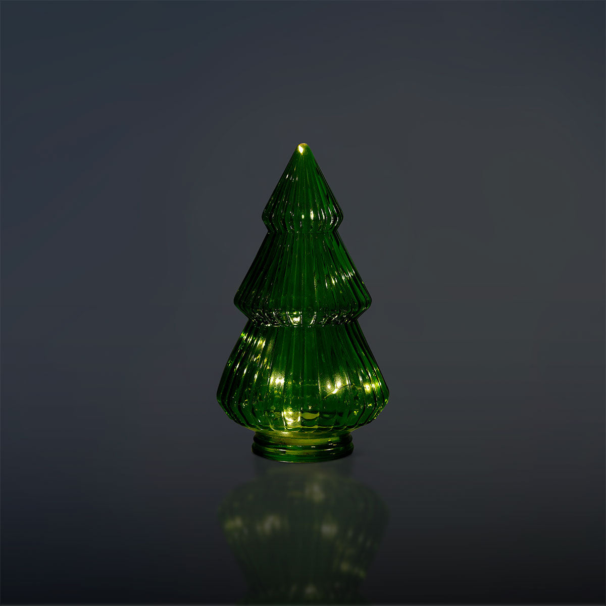 Flying Tiger Copenhagen glowing Christmas tree in a glass display, festive holiday home decor with warm lights.