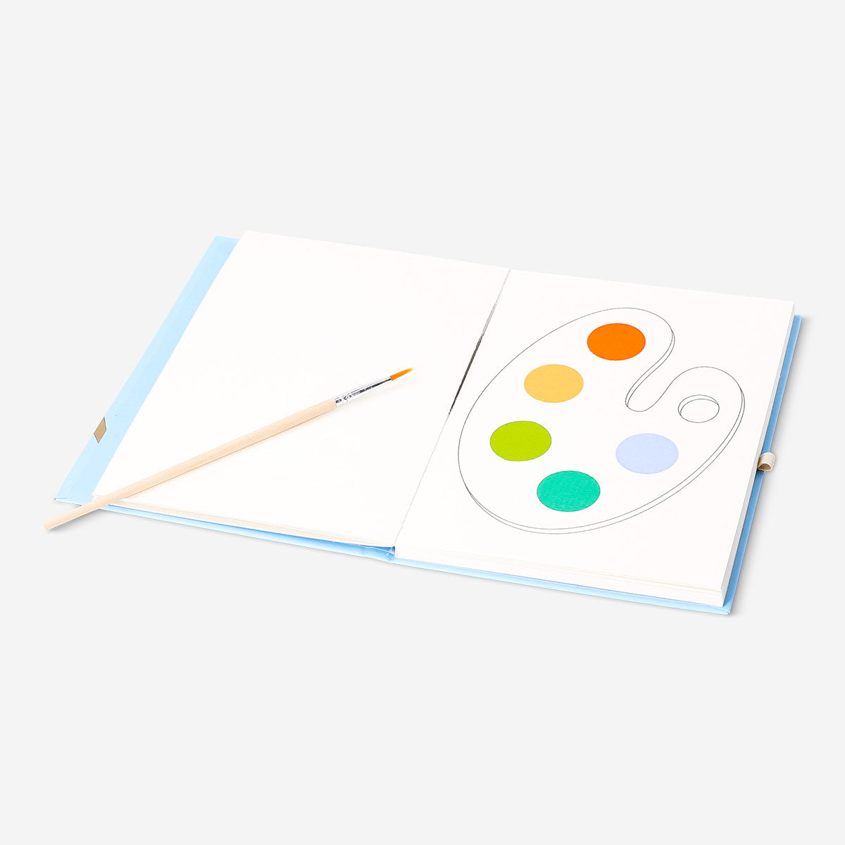 Flying Tiger Copenhagen watercoloring book with paint and brush for hobby art projects, featuring vibrant, colorful pages and art supplies.