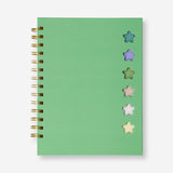 Green Flying Tiger Copenhagen office notebook with attached ballpoint pen and memos for note-taking and organization.