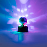 Flying Tiger Copenhagen rotating disco light gadget with colorful LED lights and rotating mirror for party entertainment.