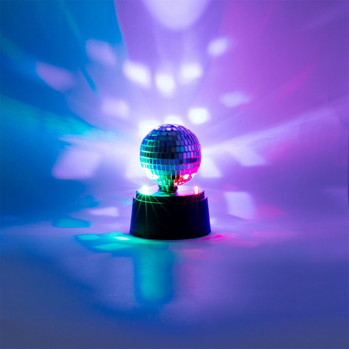 Flying Tiger Copenhagen rotating disco light gadget with colorful LED lights and rotating mirror for party entertainment.