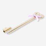Gold ballpoint pen with key and bow design by Flying Tiger Copenhagen, ideal for office use.