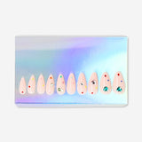 Flying Tiger Copenhagen press-on nails with heart and rhinestone designs, showcasing a stylish and decorative personal care accessory.