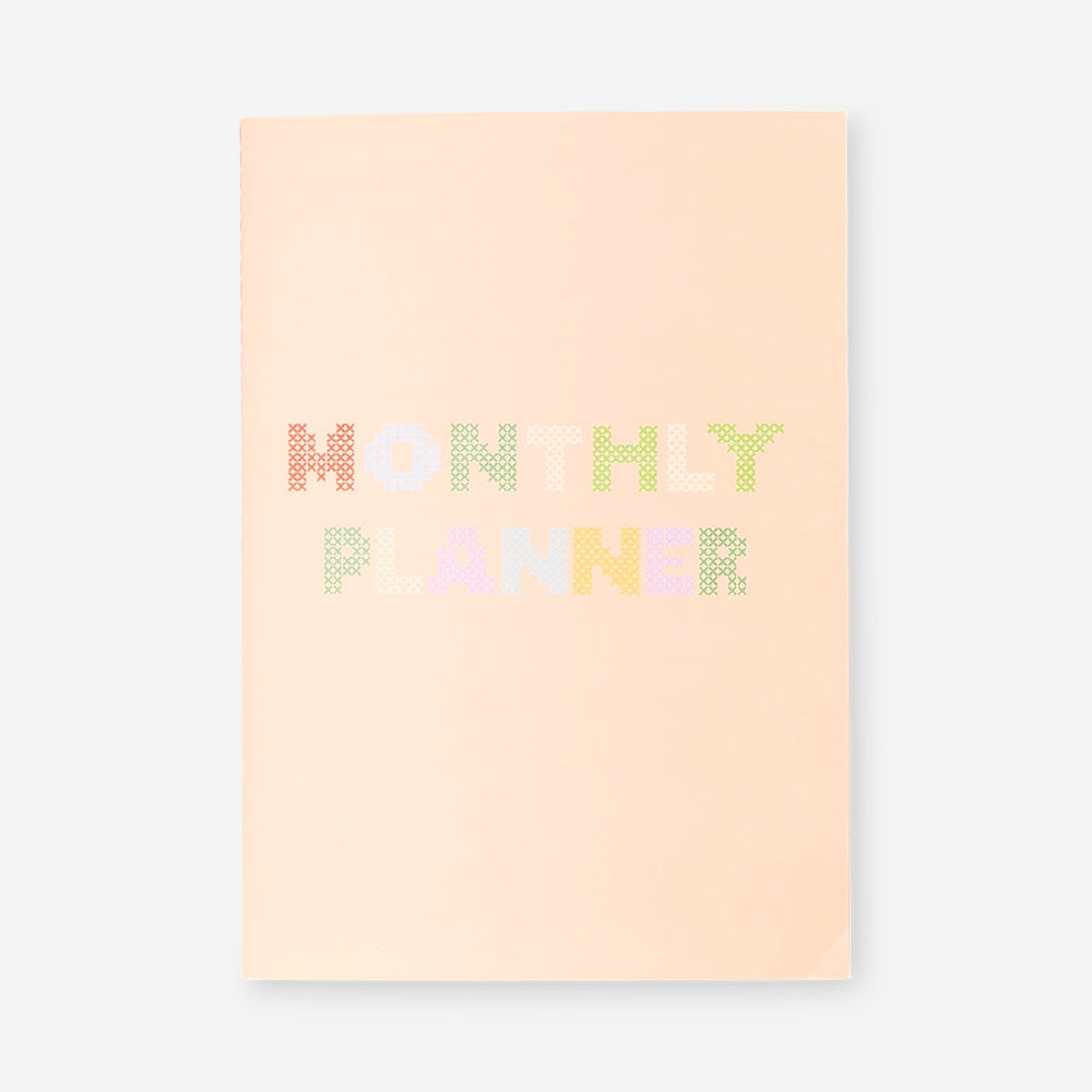 Flying Tiger Copenhagen monthly planner notebook with a colorful cover, designed for organizing and planning office tasks.