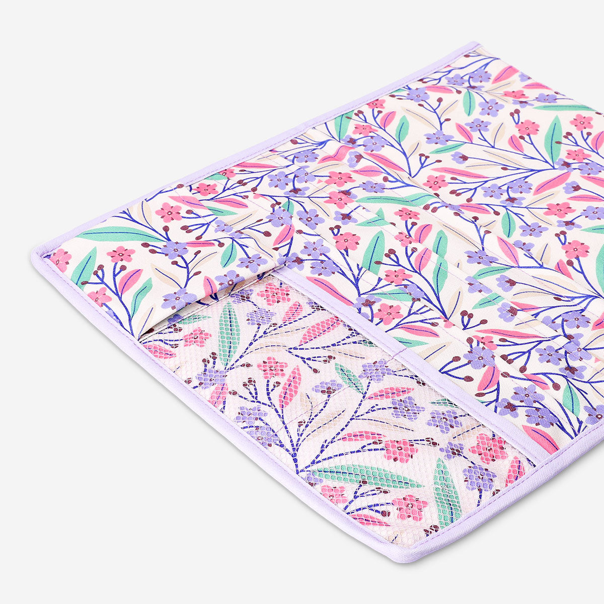 Floral bed pocket from Flying Tiger Copenhagen, 44x39 cm, shown hanging on a bed frame with colorful floral design.