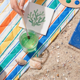 Three colorful DIY ceramic tiles for hobby crafting, featuring vibrant patterns and designs from Flying Tiger Copenhagen.