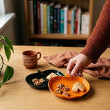 Two reusable pumpkin-shaped party plates from Flying Tiger Copenhagen, eco-friendly dinnerware for festive occasions