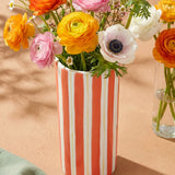 Orange striped ceramic vase from Flying Tiger Copenhagen, 20 cm tall, with flowers inside, designed for home decor.