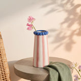 Ceramic vase with pink stripes, 15 cm tall, designed for home decor, by Flying Tiger Copenhagen, with flowers inside.