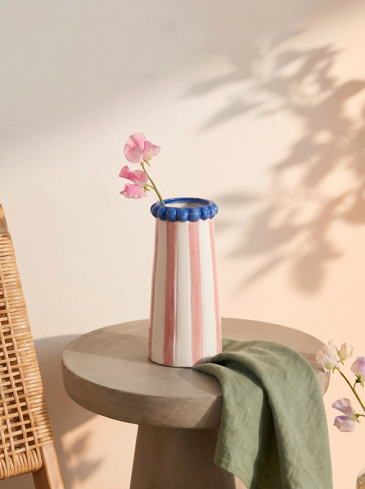Ceramic vase with pink stripes, 15 cm tall, designed for home decor, by Flying Tiger Copenhagen, with flowers inside.