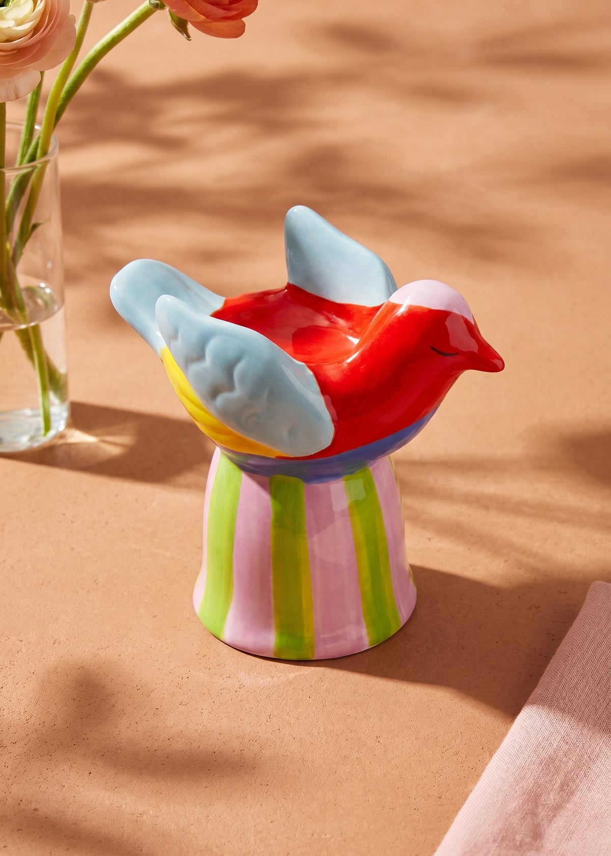 Ceramic bird tealight holder with a striped base, decorative home accessory by Flying Tiger Copenhagen.