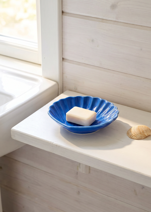 Blue ceramic seashell soap dish from Flying Tiger Copenhagen, with a detailed seashell design for home decor.